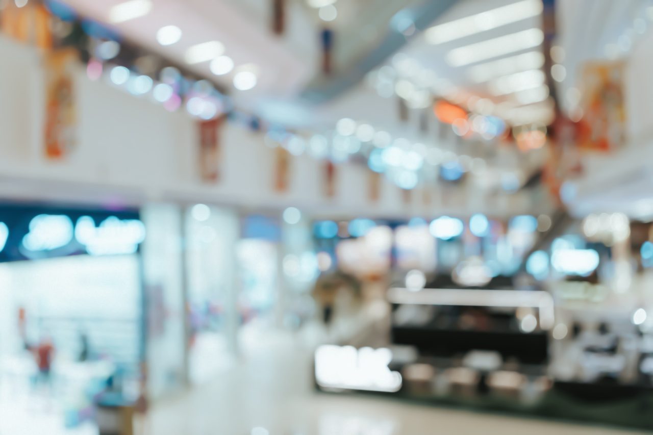 Digital marketer analyzing data dashboards on laptop and smartphone, showing how Artificial Intelligence tools optimize campaigns and drive business growth.